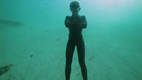 Guillaume Nery base jumping at Deans Blue Hole, filmed on breath hold by Julie Gautier